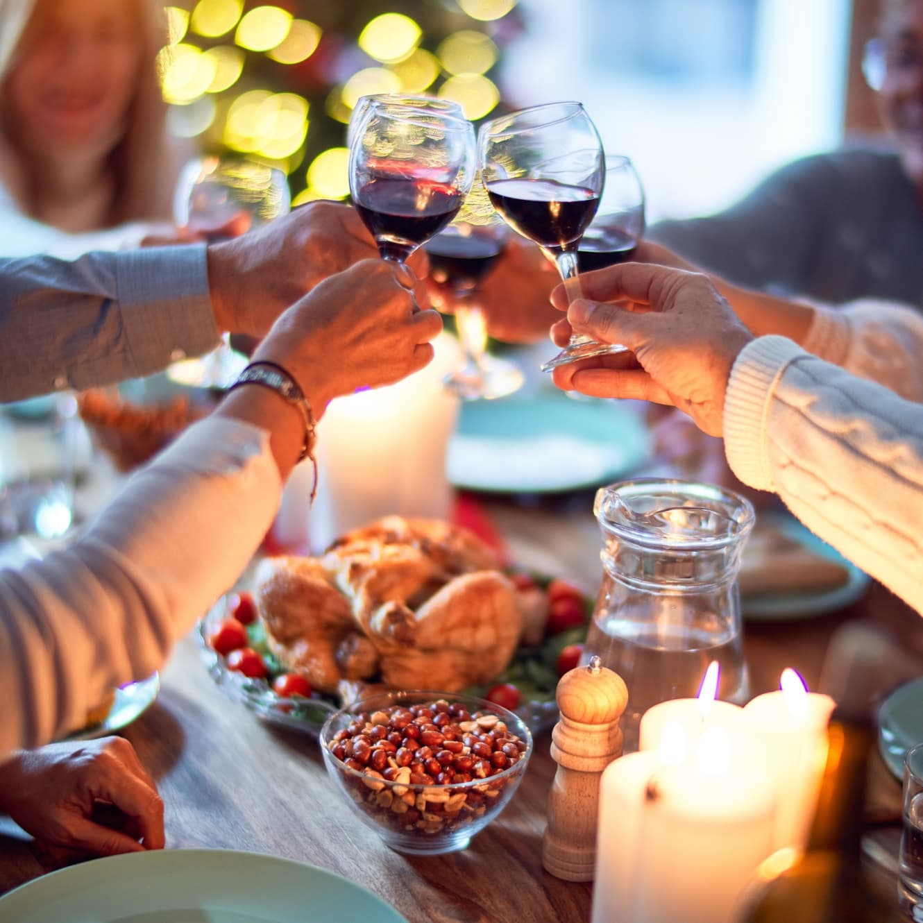 People enjoying a Christmas meal with wine
