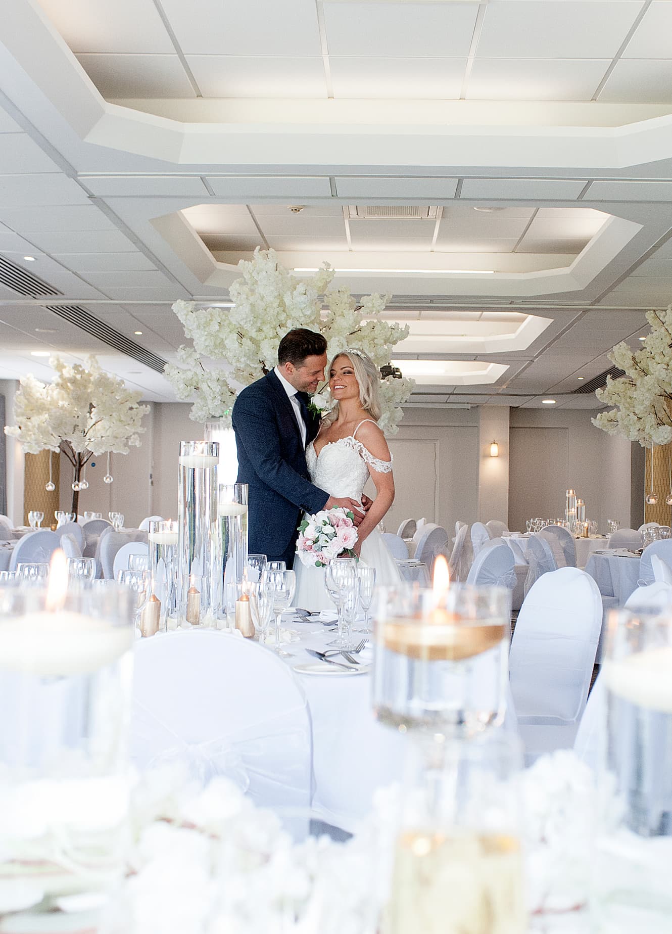 Couple embracing in the dining hall on their wedding day