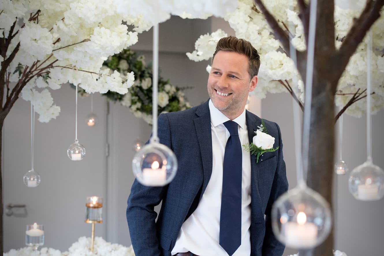 Couple celebrating their wedding with a glass of fizzy wine on a golf caddy